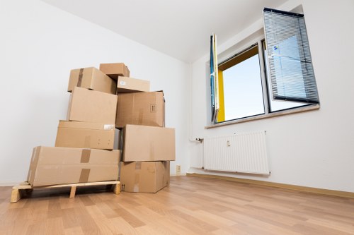Residential packing setup with boxes, tape, and protective wrap for a move in Cubitttown